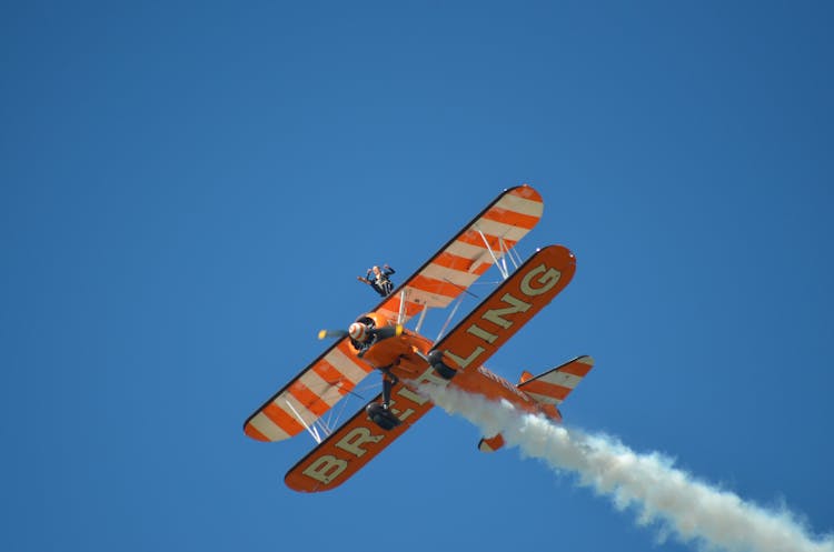 A Biplane Flying In The Sky