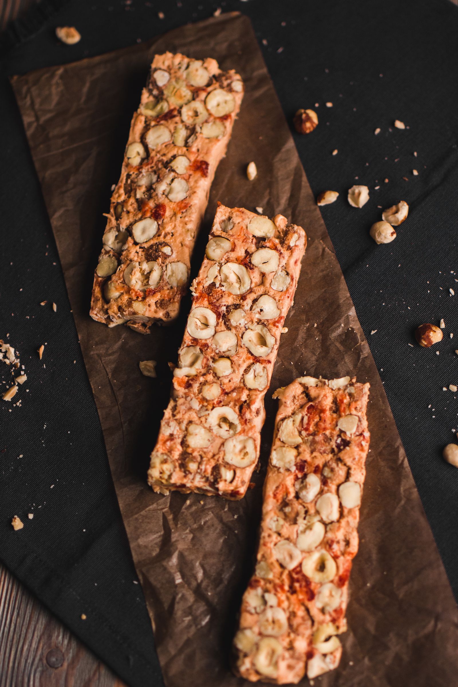 Several protein bars arranged on parchment paper for a side-by-side comparison