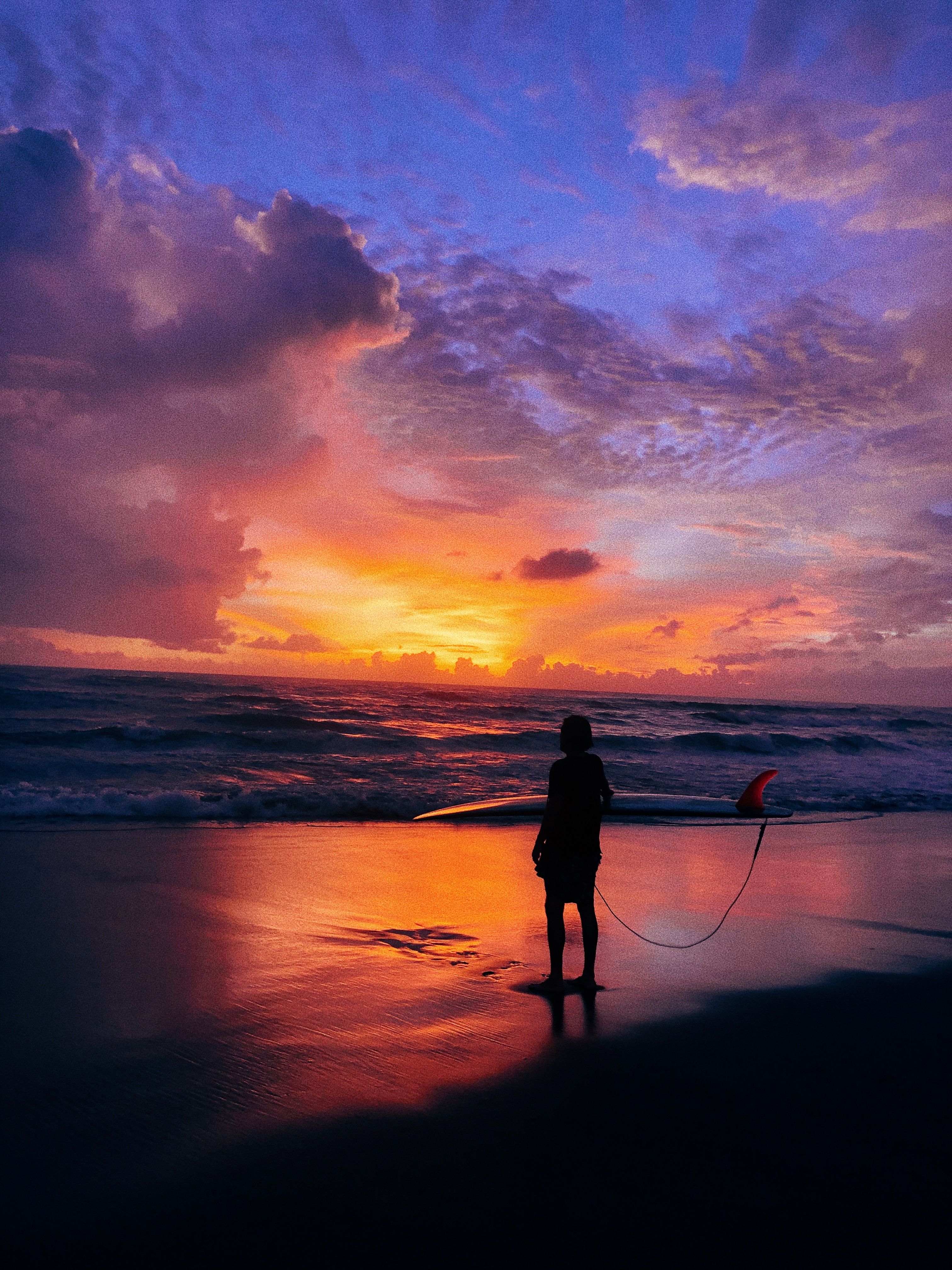 Silhouette of a Person Standing on Seashore during Sunset · Free Stock ...
