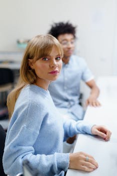 Diverse students collaborating in a modern classroom setting for higher education.