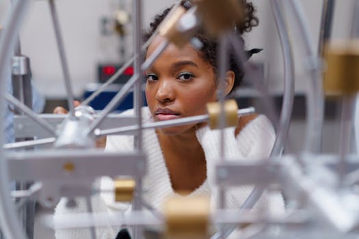 Curious teenager with curly hair exploring scientific equipment in classroom setting.
