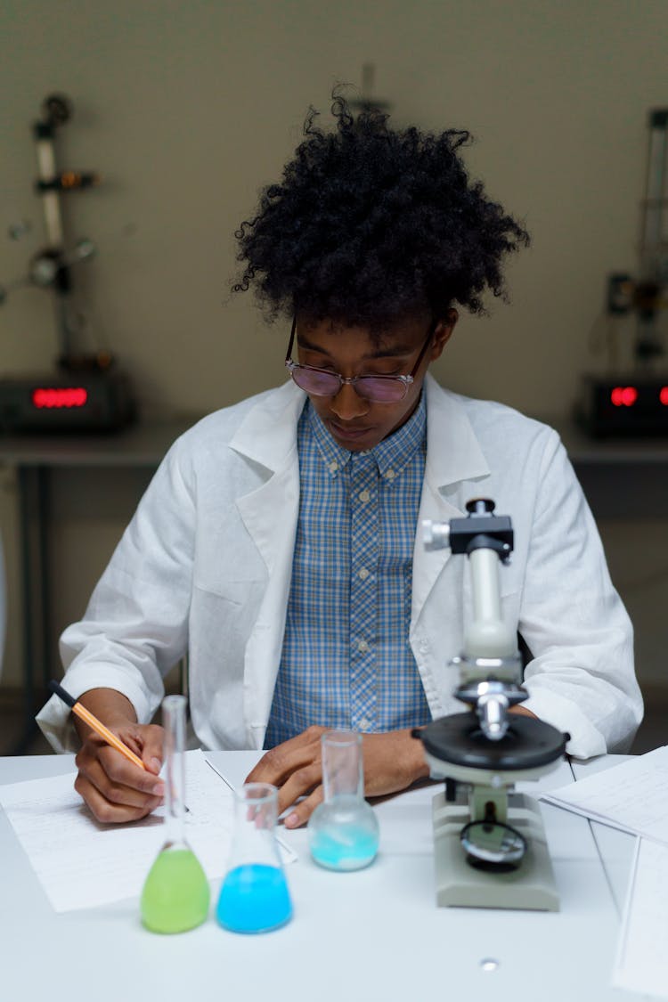 Man In A Lab Coat Researching On Colored Liquids