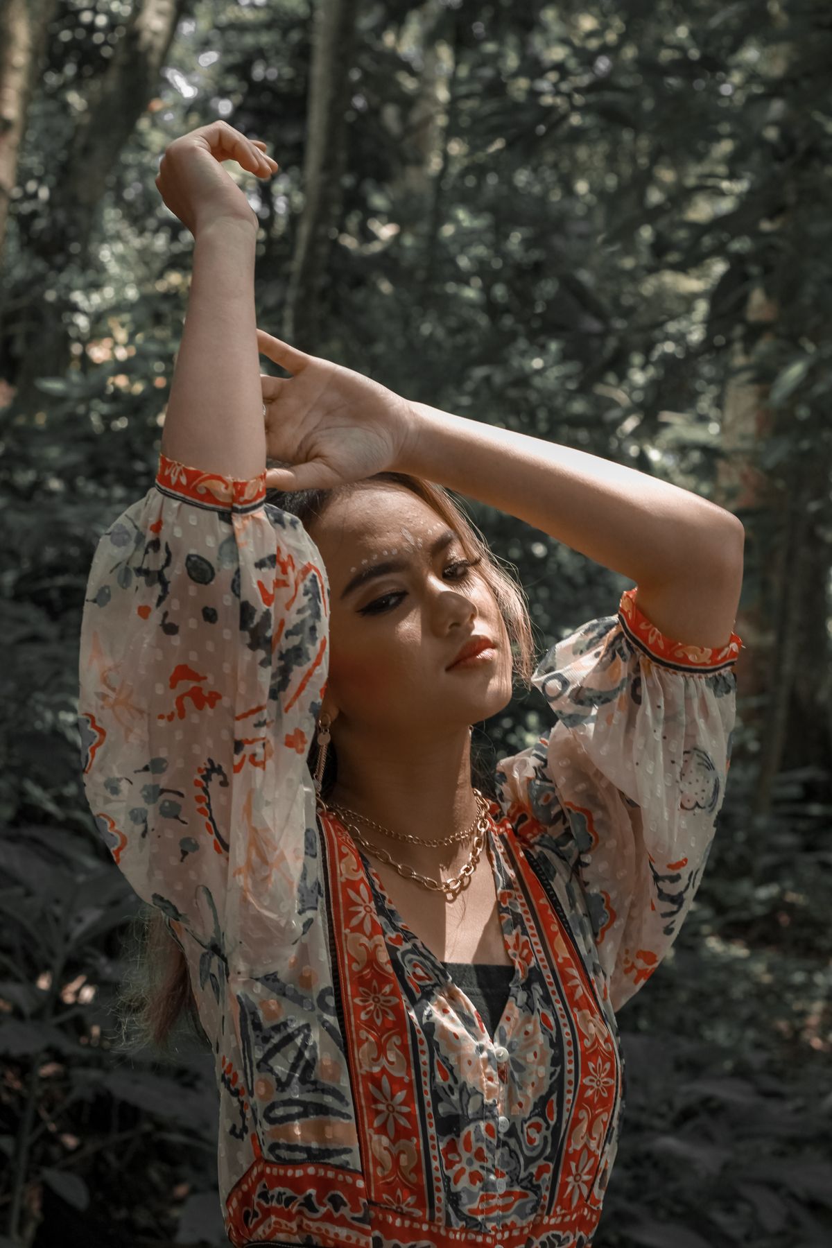 Woman in bohemian style dress in forest setting