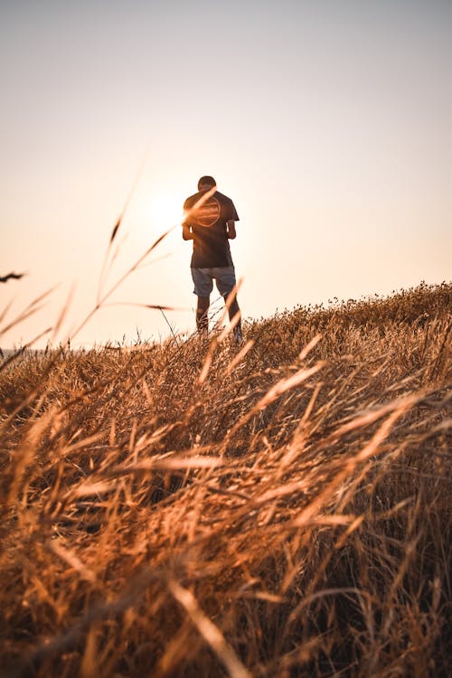 Back View of a Person Standing on Grass