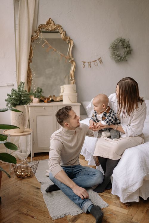 Free A family enjoying a lovely moment together in a beautifully decorated bedroom with winter theme. Stock Photo