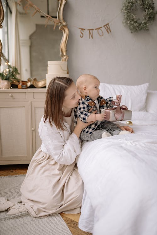Free Mother Holding Her Cute Baby Stock Photo