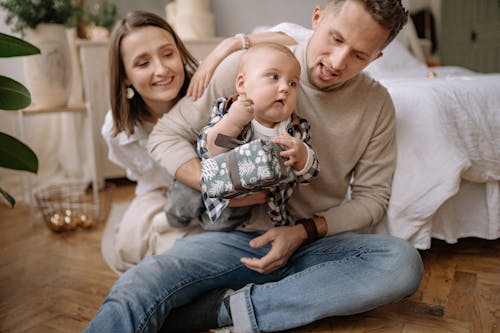 Free Happy Family Sitting on the Floor Stock Photo