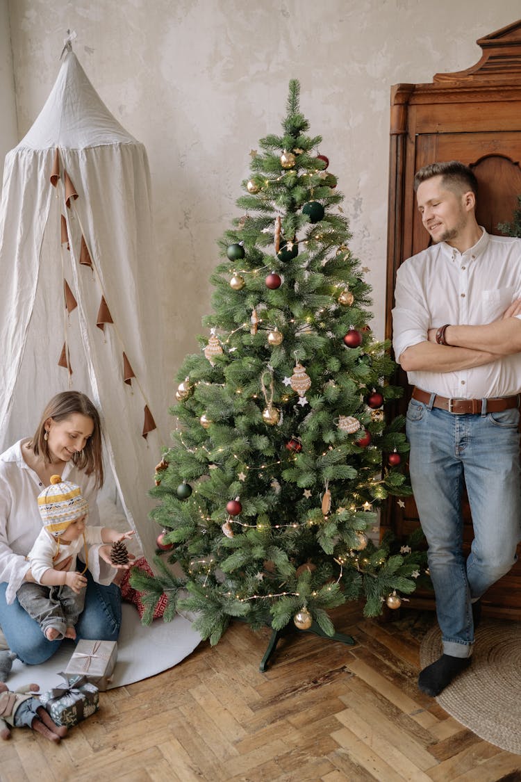 Family Looking At The Christmas Tree