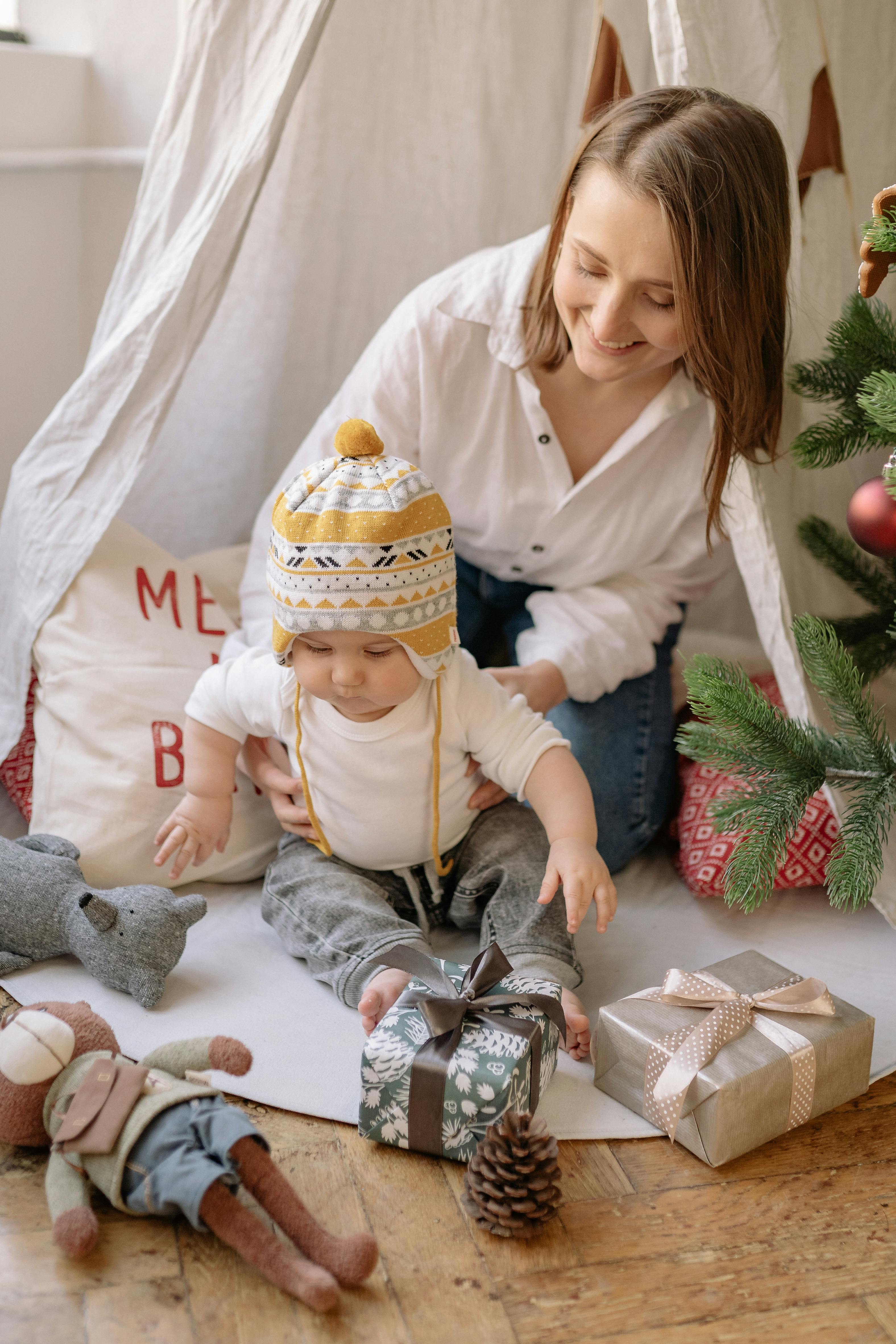 mother and baby playing with the gifts