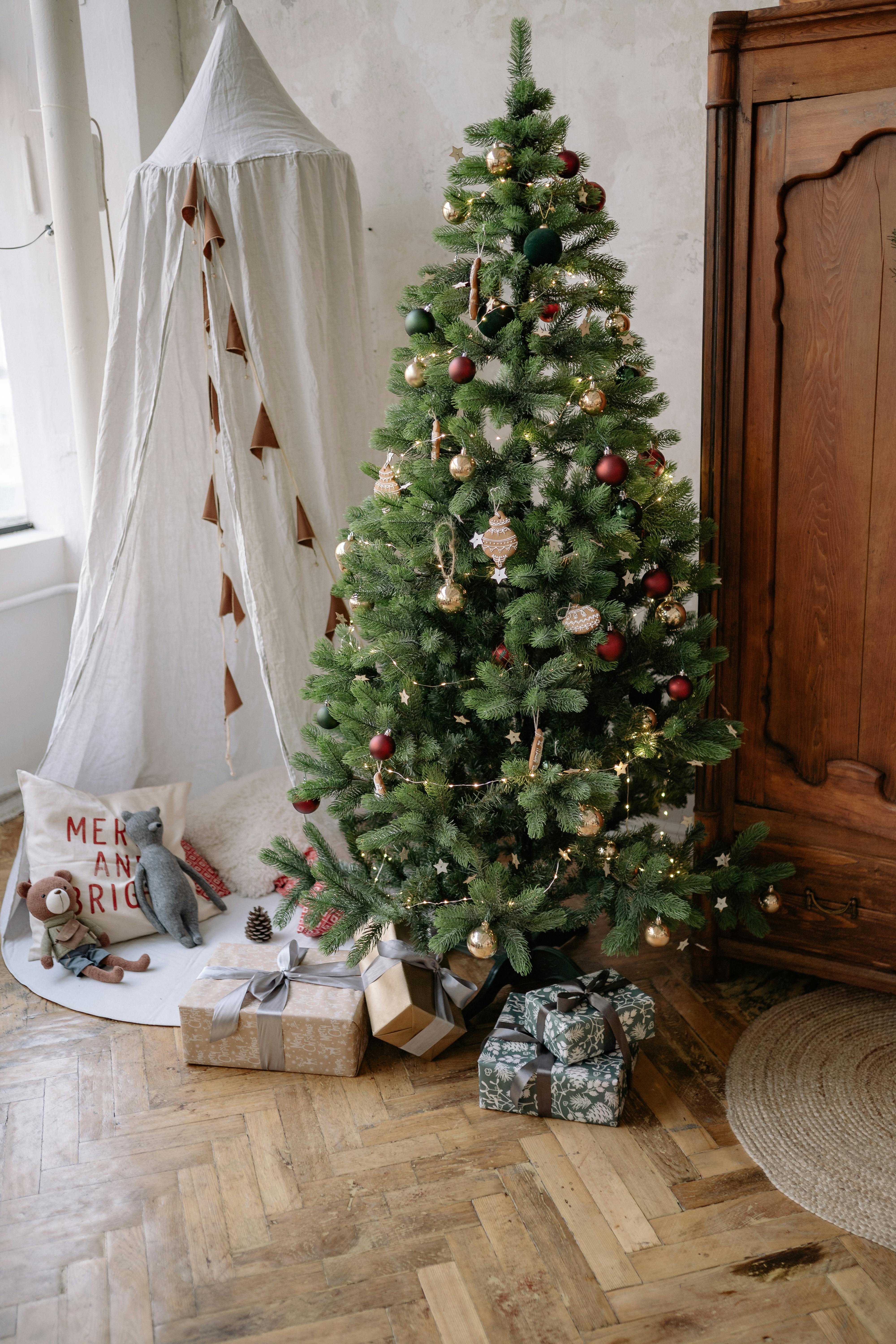 Charming indoor scene featuring a decorated Christmas tree, gifts, and festive accents for a warm holiday vibe.