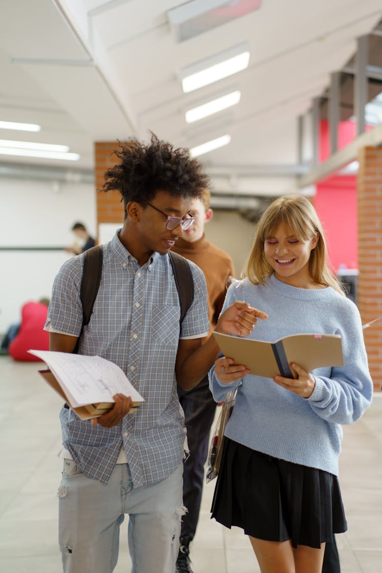 Young Man And Woman Having A Conversation At School