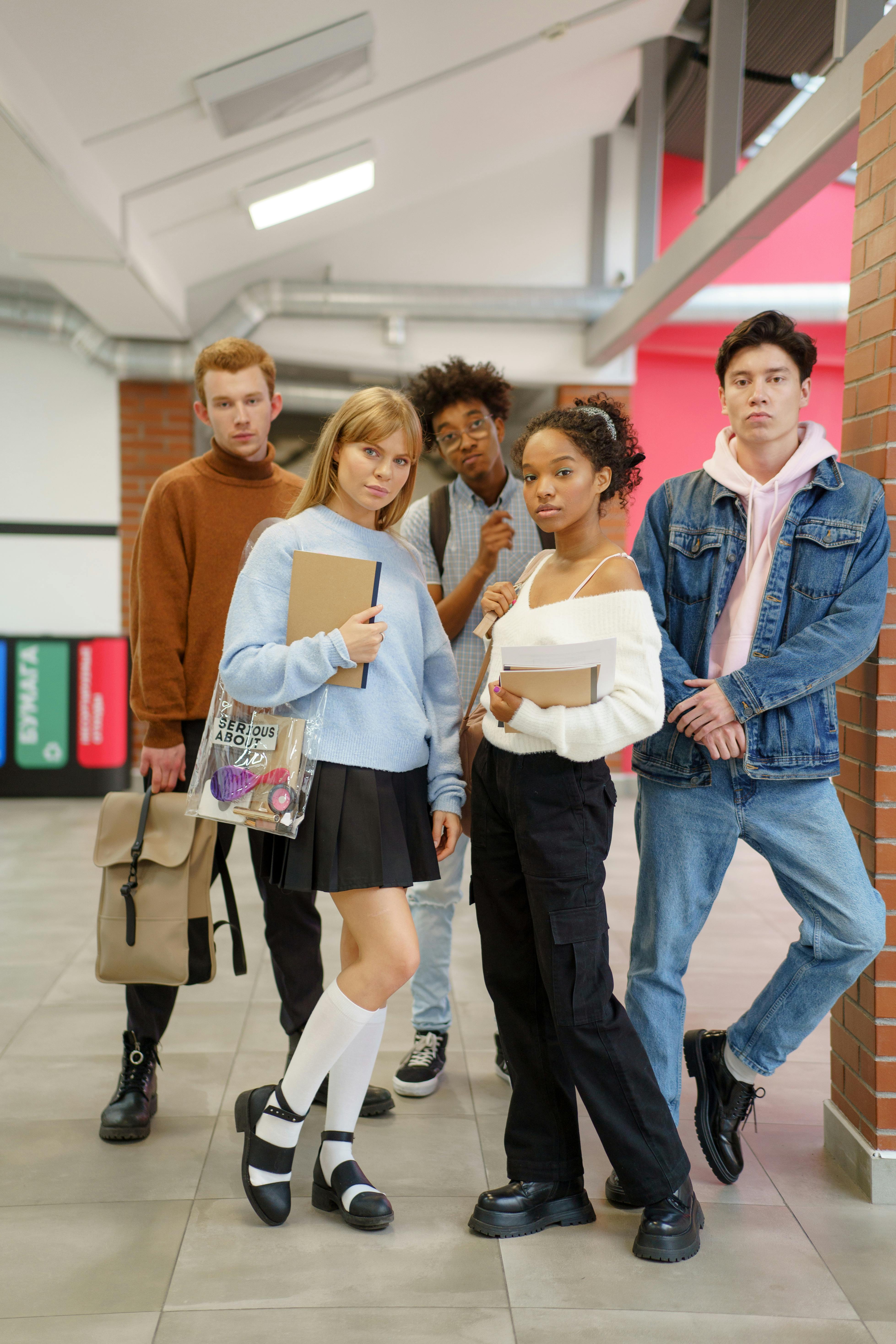 group of young people standing in a school hallway