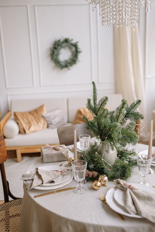 Free Elegant holiday decor with Christmas table setting and sofa in cozy living room. Stock Photo
