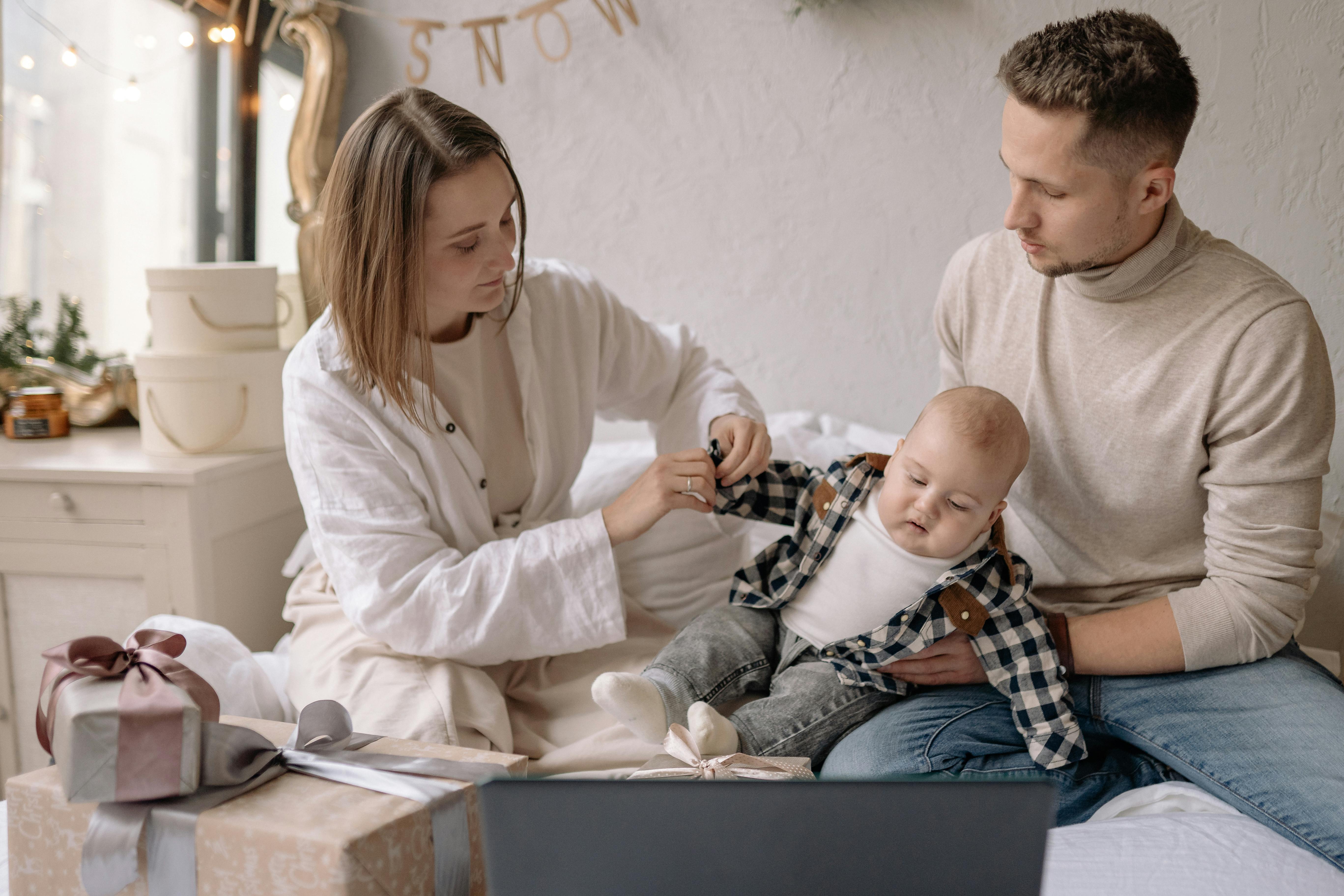 family sitting on bed