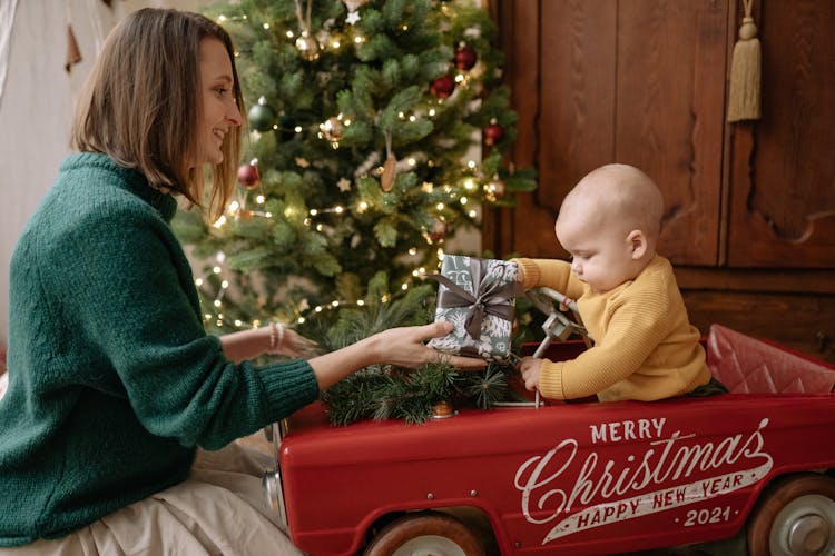 A Mother Giving A Present To A Baby