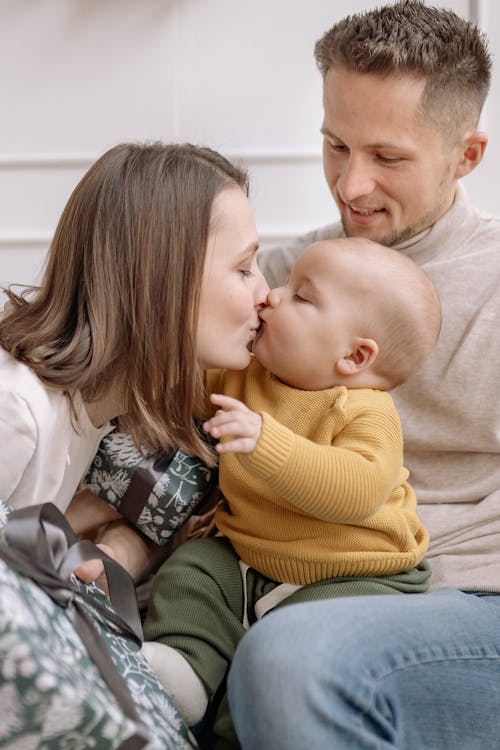 Free A Mother Kissing Her Baby Stock Photo