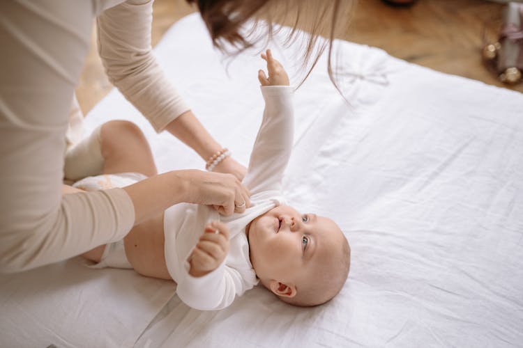 Mother Dressing Baby