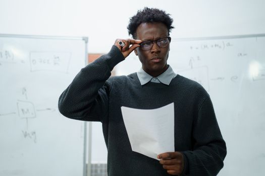 A Man in Gray Knitted Sweater Wearing Eyeglasses while Looking Afar