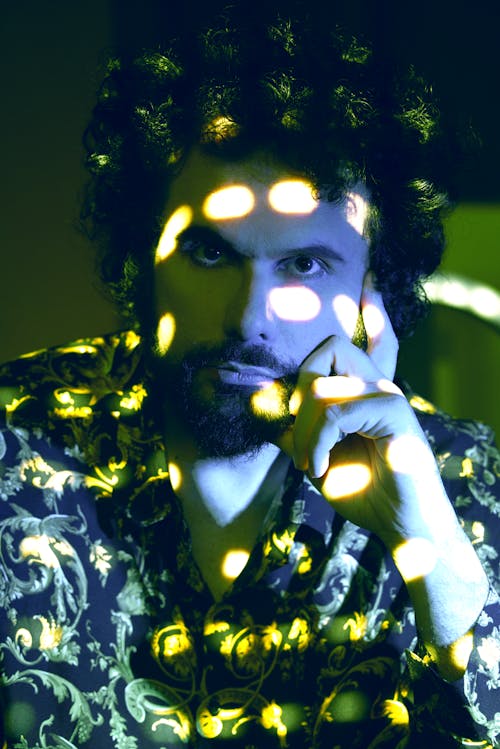 Portrait of a Man in Electric Blue and Yellow Lights