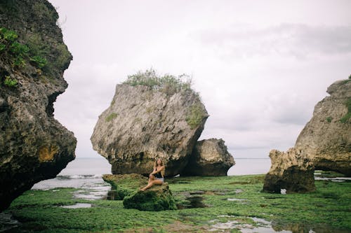 Woman Wearing Sitting on Rock Formation