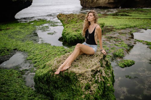 Free Beautiful Woman Sitting on Rock  Stock Photo