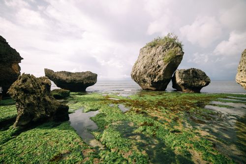 Free Stunning coastal view featuring large rock formations by the sea under a clear sky. Stock Photo