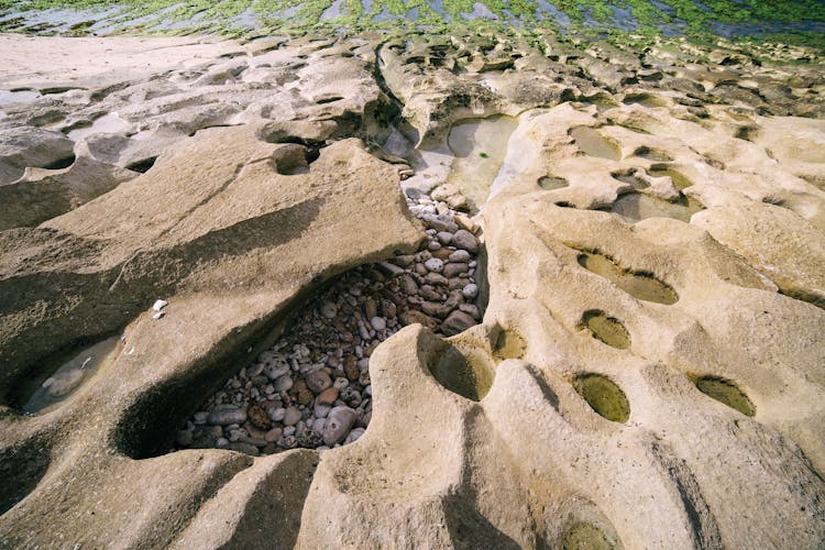 Rocks Hidden In Hole In Sand