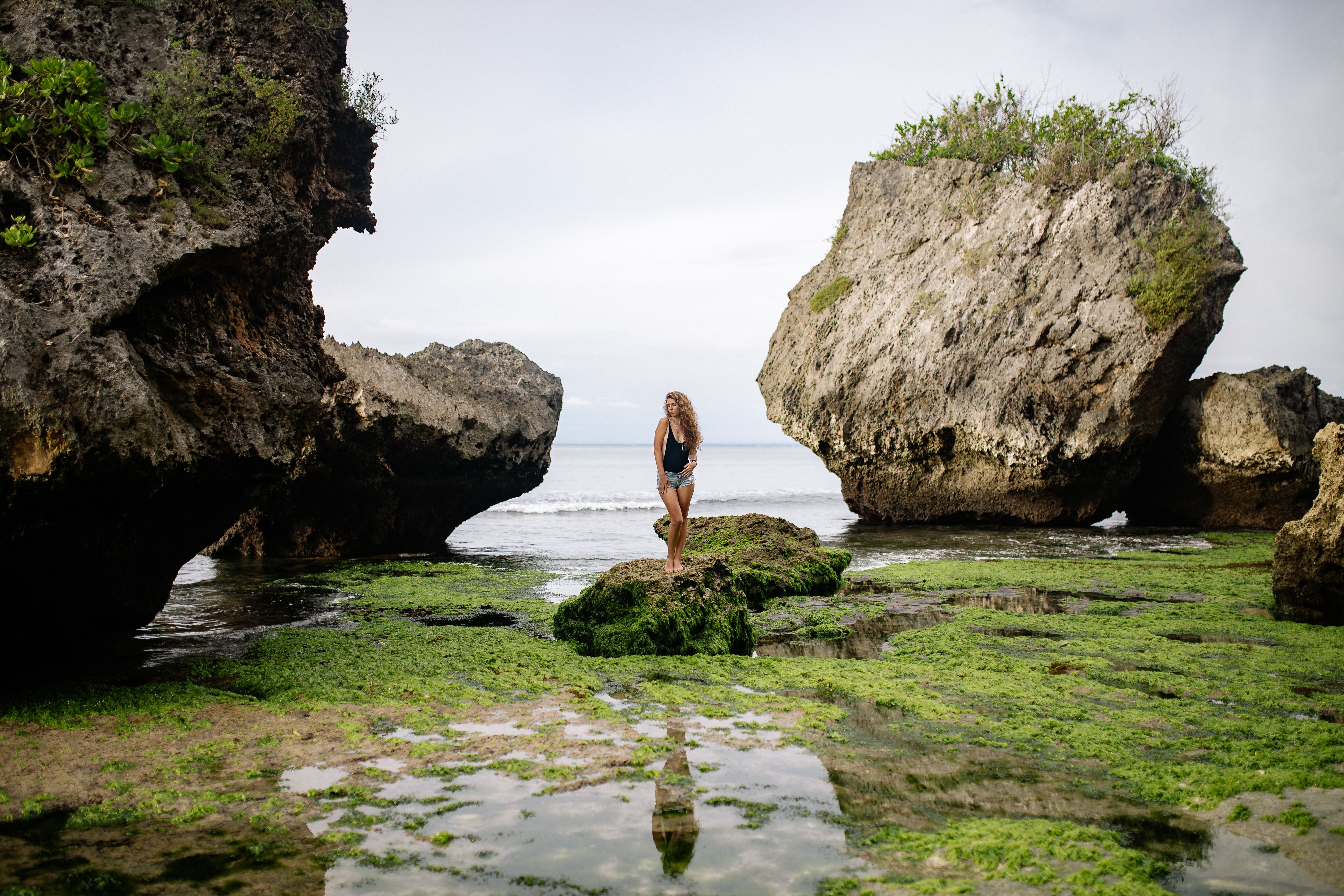 Woman in Bikini Posing on Rock at Beach · Free Stock Photo