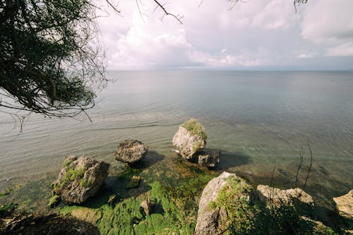 View of Sea and Coastline with Rocks on the Shore 