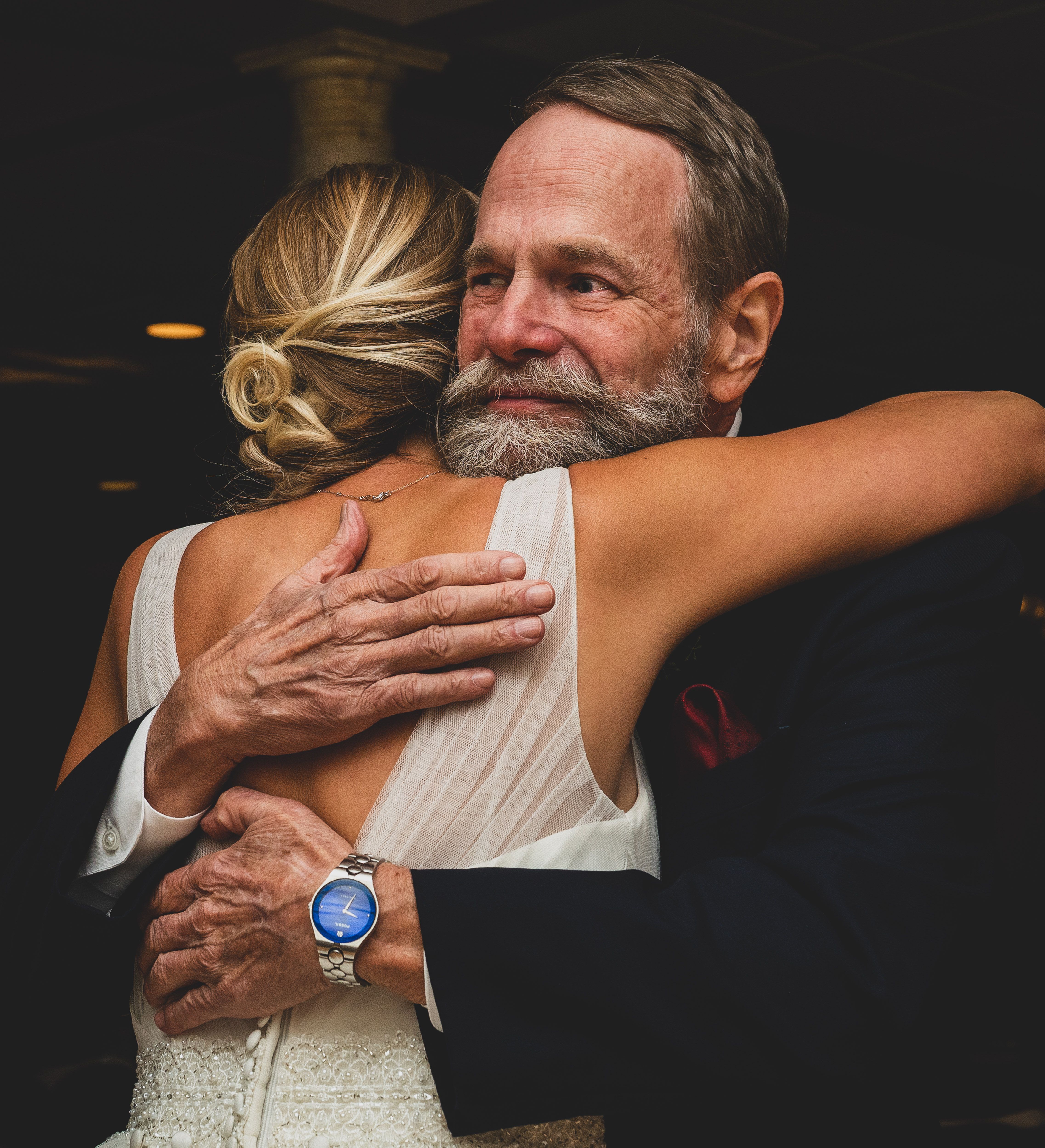 Emotional wedding moment capturing a father-daughter embrace, showcasing love and connection.