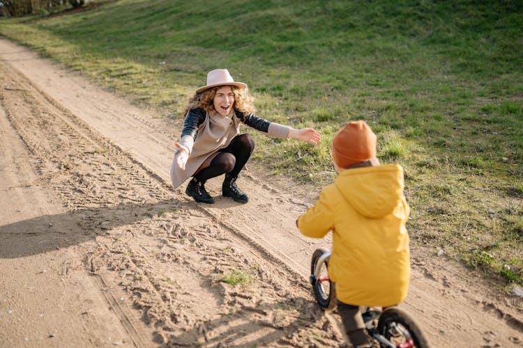 Happy Woman And Child On Bike