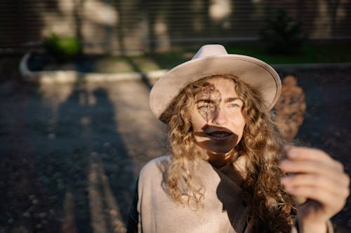 Portrait of Woman Holding out Leaf