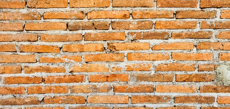 Close-up of an orange brick wall showcasing texture and pattern, ideal for backgrounds.