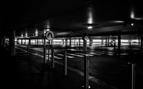 Free Moody black and white parking space with dramatic lighting and shadows. Stock Photo