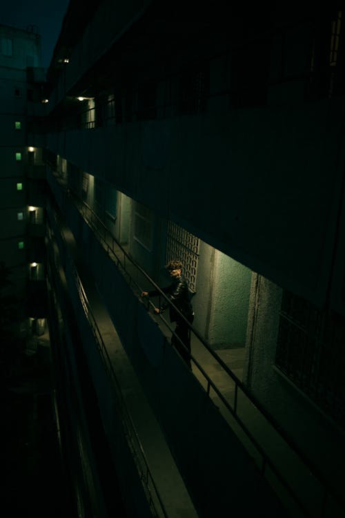 Man on Balcony of Mysterious Building