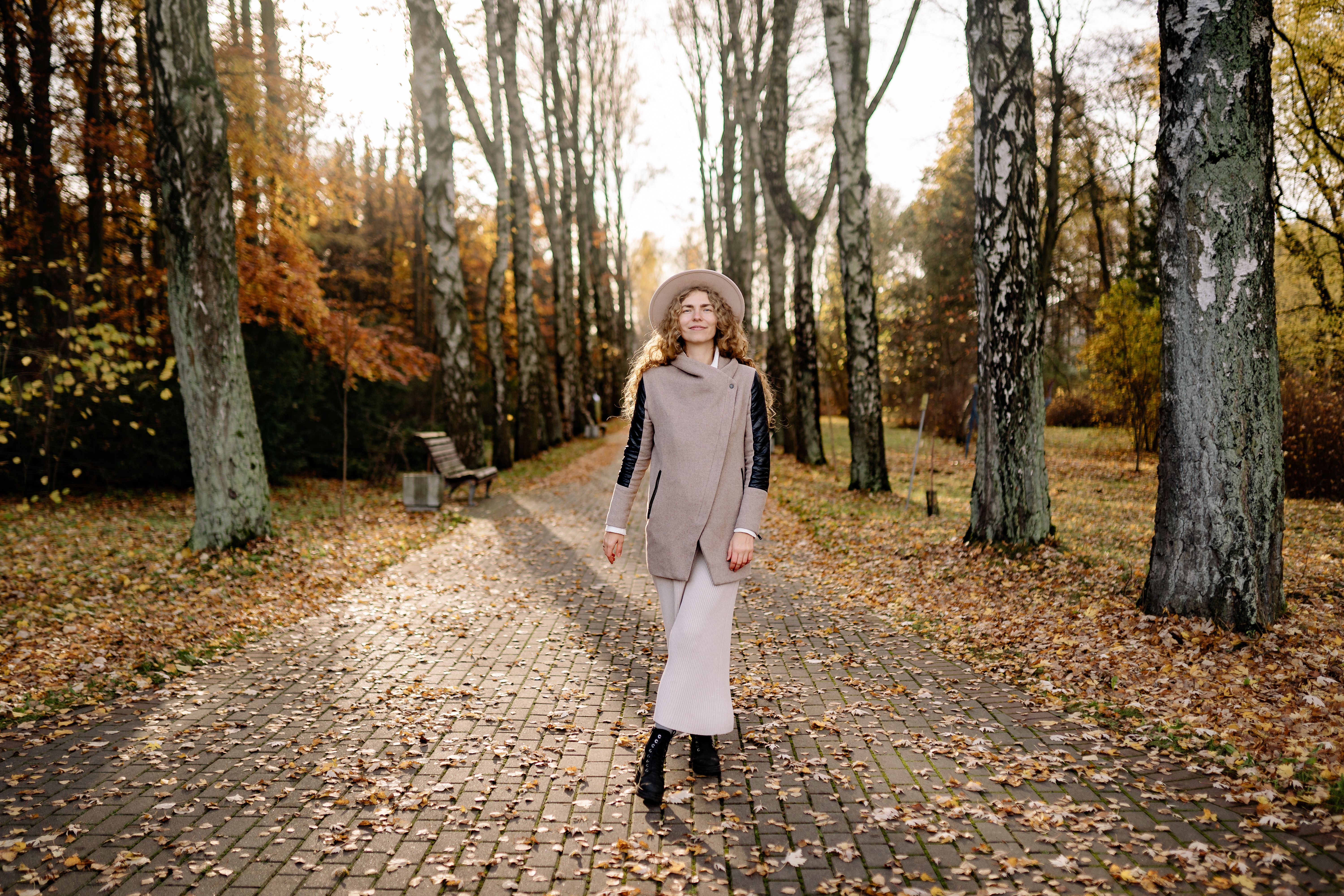 A woman in an elegant tailored coat and hat — the classic British coat-dress look.