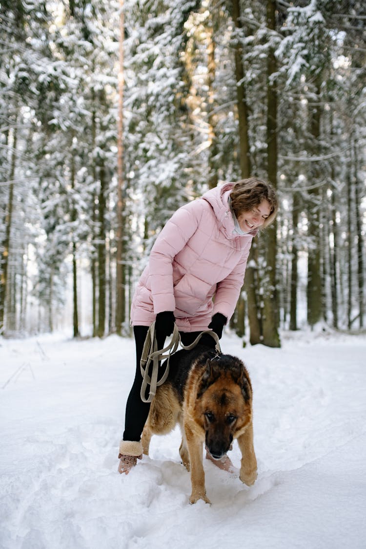 Woman With A Dog In Forest At Winter 