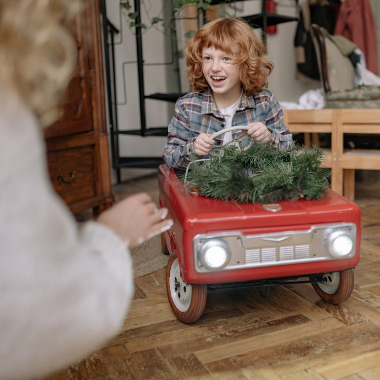 Boy Driving A Toy Car 