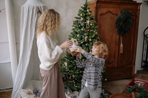 Free Boy Giving Gift to a Woman Stock Photo