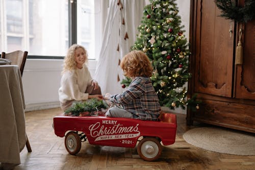 A Boy Riding in a Toy Car on Christmas