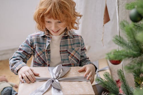 Free Boy Feeling Excited With A Gift  Stock Photo