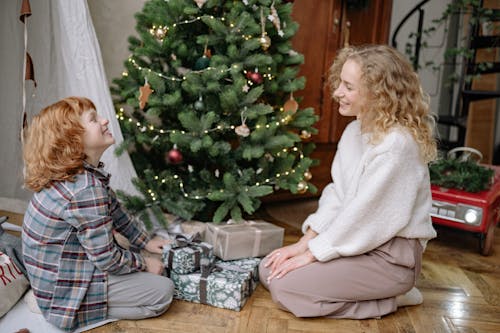 Free Mother And Son Sitting By A Christmas Tree Stock Photo