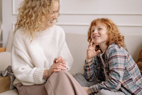 Free A joyful mother and son bonding indoors, smiling and enjoying each other's company. Stock Photo