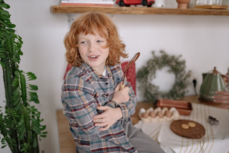 A Boy Holding A Spatula