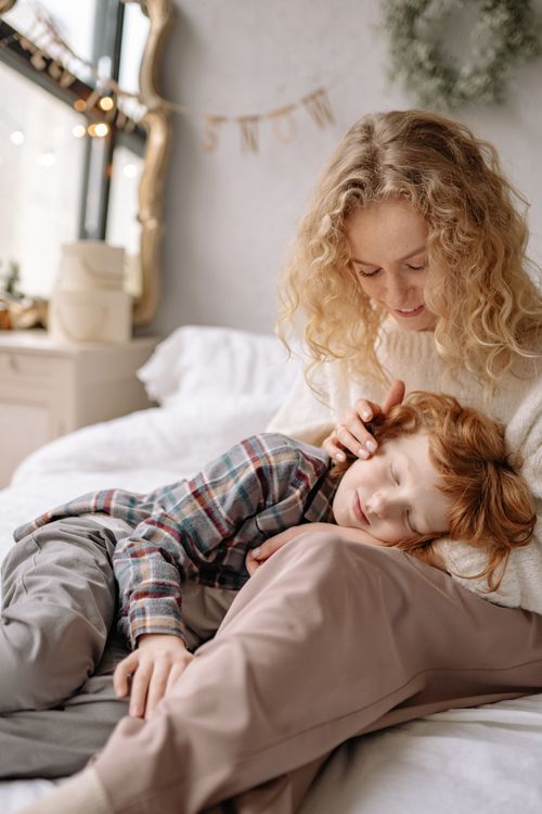 Free Warm and tender moment of a mother and son bonding indoors, capturing affection and comfort. Stock Photo