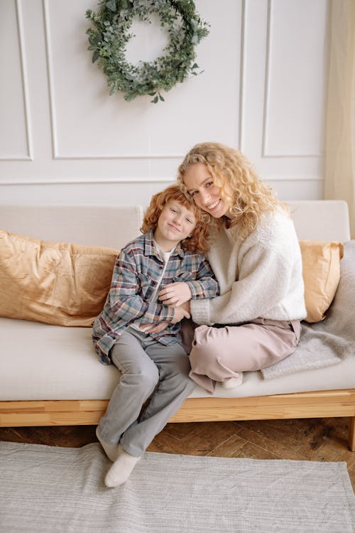 A Woman Sitting on a Couch with her Son