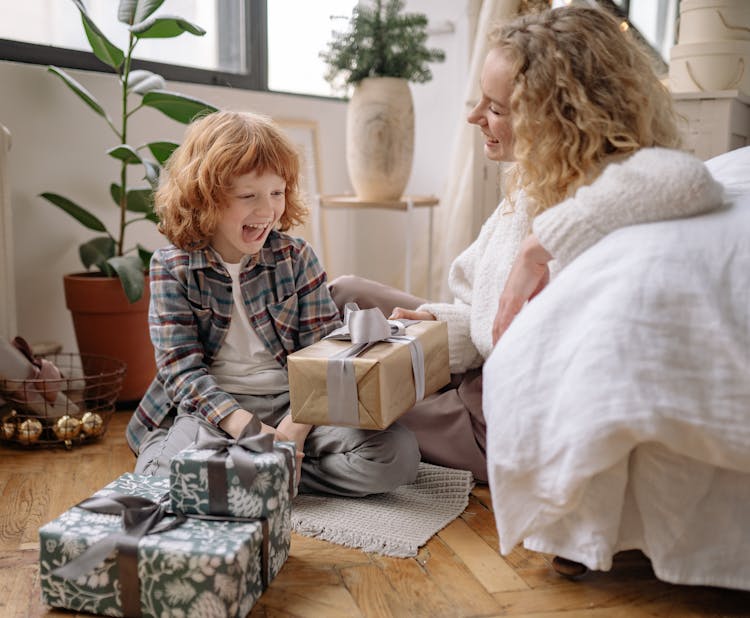 Child Receiving Gift From Mother