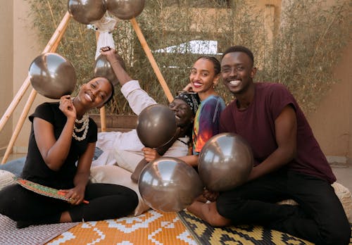 Happy People with Balloons at Outdoors Party