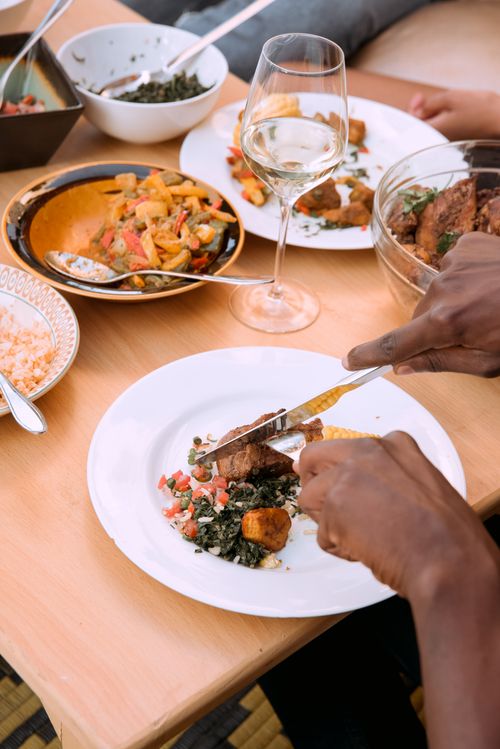 Free Elegant dining setup with diverse dishes and a glass of wine, showcasing a gourmet meal. Stock Photo