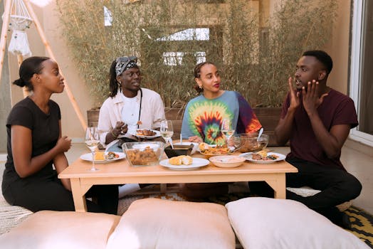 A group of friends happily sharing a meal indoors, creating joyful memories.